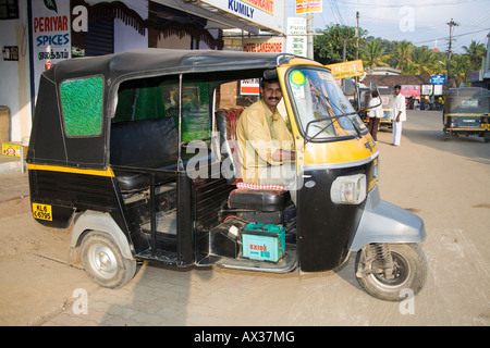 A Tuk Tuk parked in a street, outside shops, Kumily, Kerala, India Stock Photo