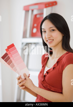 Asian woman holding paint samples Stock Photo