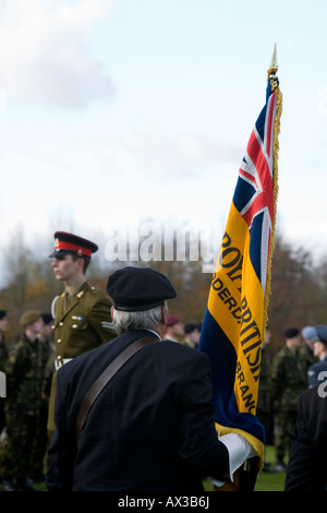 Royal British Legion standard bearer & soldier in military uniform - outdoor memorial service, Stonefall Cemetery, Harrogate, Yorkshire, England, UK. Stock Photo