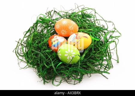Four easter eggs in a nest isolated on white Stock Photo