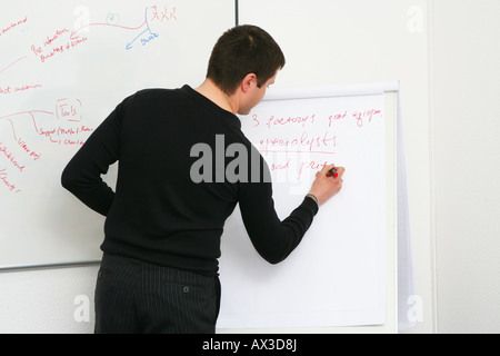 Student writes on the board Stock Photo