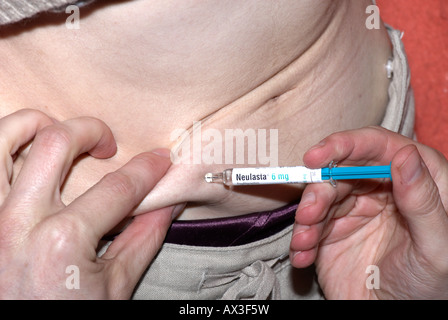 Giving an injection in tummy with Neulasta after chemotherapy Stock ...