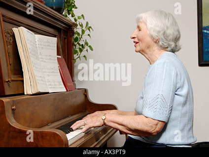 View of an elderly woman playing a piano  Stock Photo