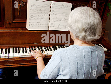 View of an elderly woman playing a piano  Stock Photo