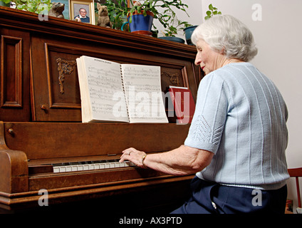 View of an elderly woman playing a piano  Stock Photo