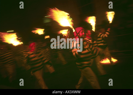 Bonfire Boys carrying  flares down the streets of lewes during the bonfire night celebrations Stock Photo