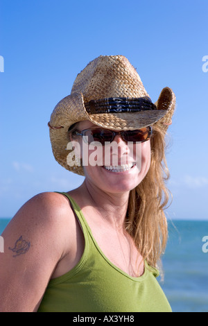 One blond woman wearing straw cowboy hat in Key West, Florida, USA Stock Photo