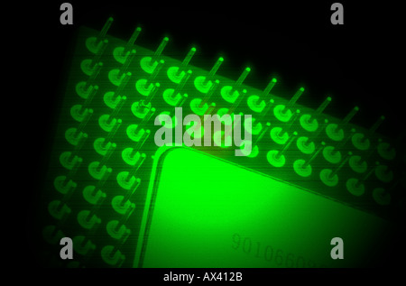 microprocessor computer chip under green light closeup Stock Photo