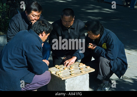 China, Beijing. Men playing Chinese Chess in a local neighbourhood Hutong. Stock Photo