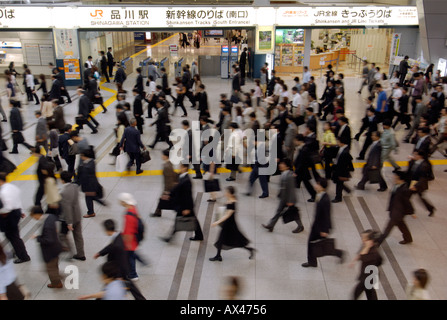 Morning rush hour commuters walk through Shinagawa Station in Tokyo Japan Stock Photo