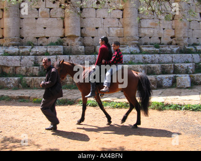 Horse riding for local tourists on the archaeological site 'Mauritanian royal tomb', Tipasa, Algeria, North Africa Stock Photo