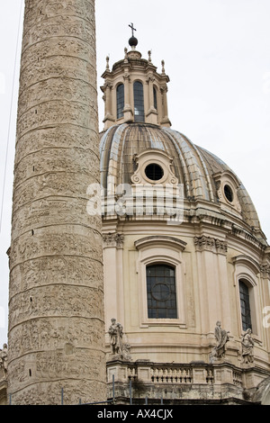 Section of Trajan's Column with the dome of Nome di Maria in the background Stock Photo