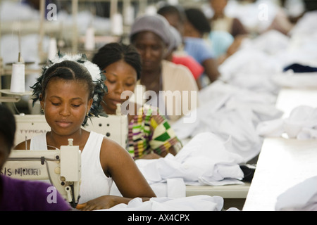 Female workers on assembly line in an apparel factory Stock Photo