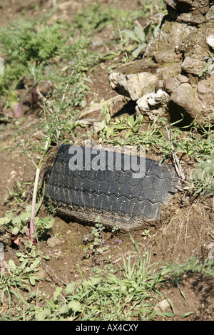 car tyre dumped in countryside Stock Photo