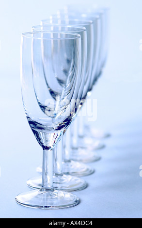 Close up of row of empty sherry glasses glass on white background Stock Photo
