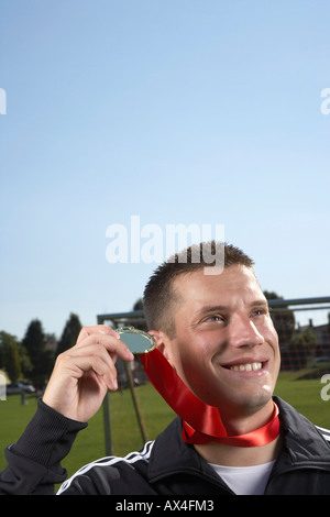 Man Holding Medal Stock Photo