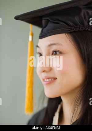 Asian woman wearing graduation cap Stock Photo