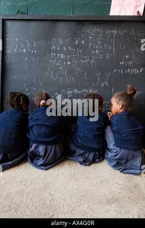 Ethiopia 2008 Addis Ababa Karakore township. Girls writing on blackboard in primary school class. Stock Photo