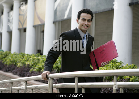 Portrait of a businessman holding a file and smiling Stock Photo