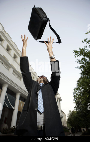 Low angle view of a salesperson throwing his bag Stock Photo