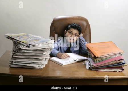 Portrait of a boy working in office and looking tired Stock Photo