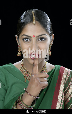 Portrait of a south Indian woman with a finger on lips Stock Photo - Alamy