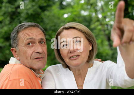 Mature woman showing man something Stock Photo