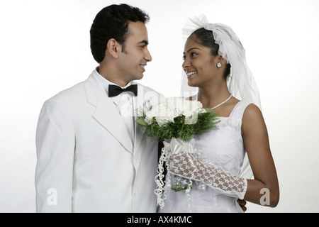 Bride and groom looking at each other and smiling Stock Photo