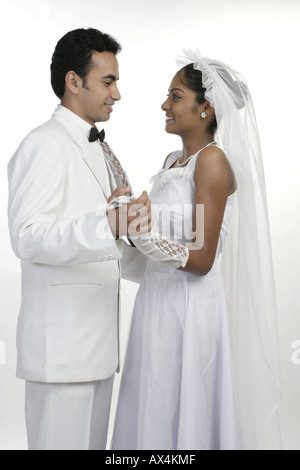 Side profile of a bride and a groom dancing and smiling Stock Photo
