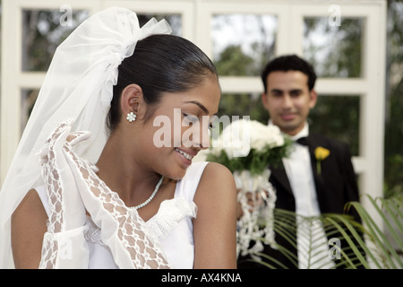 Close up of a bride blushing with her groom standing behind her Stock Photo