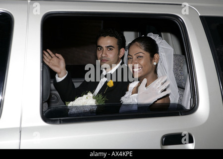 Portrait of a married couple sitting in a car and smiling Stock Photo
