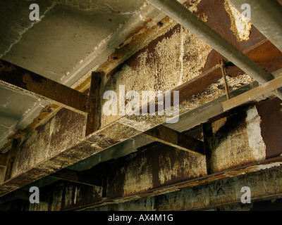 Rusty corroded steel beams supporting bridge. Stock Photo