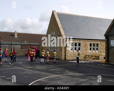 Teacher and children at organised games Danby Church of England primary school Ainthorpe North Yorkshire UK Stock Photo