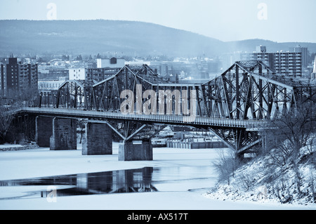 The Alexandra Bridge spanning the Ottawa River between Hull Quebec and Ottawa Ontario on a cold winter day Stock Photo