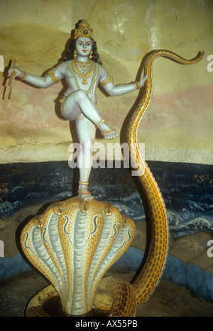 The Hindu God Lord Krishna dancing on the head of Kaliya, King of the Serpents Stock Photo