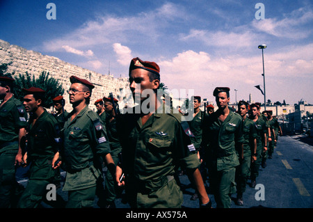 Israeli soldiers of the 35th Brigade also known as the Paratroopers Brigade parade in front of old city walls during Jerusalem day celebrations Stock Photo