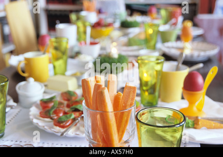 Easter table setting, focus on carrot slices in glass Stock Photo