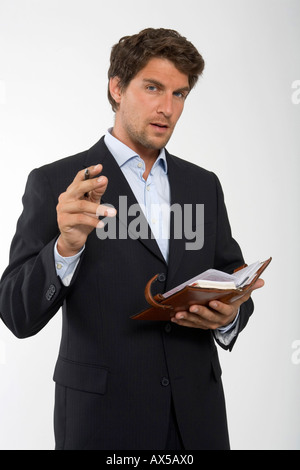 Young businessman with personal organizer, close-up, portrait Stock Photo