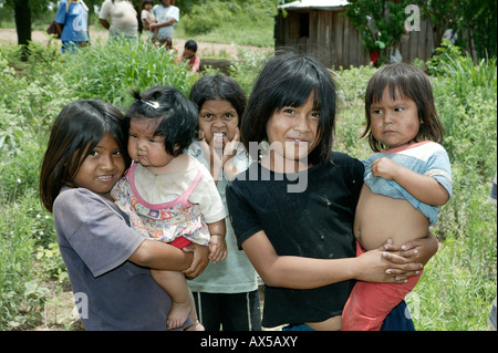 Two girls with children on their arms, Nivaclé Indians, Jothoisha, Chaco, Paraguay, South America Stock Photo