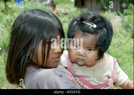 Girl with child on her arms, Nivaclé Indians, Jothoisha, Chaco, Paraguay, South America Stock Photo