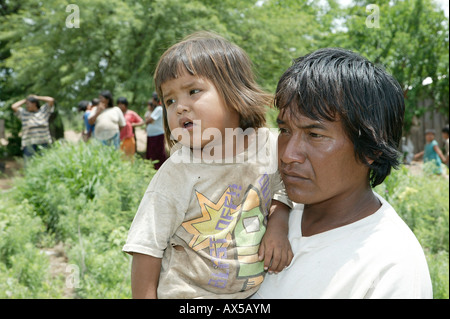Father with child on his arms, Nivaclé Indians, Jothoisha, Chaco, Paraguay, South America Stock Photo