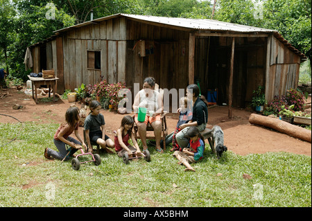 Women with children making a break in front of the house, Asuncion, Paraguay, South America Stock Photo