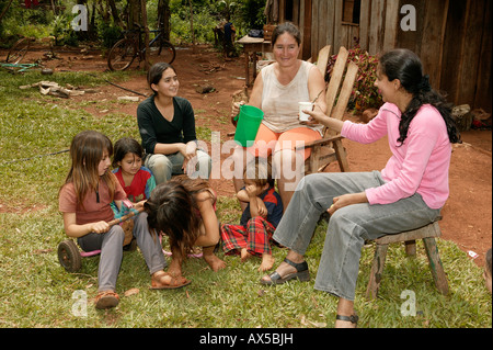 Work break in front of the house, women with children, Asuncion, Paraguay, South America Stock Photo