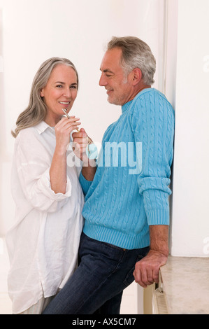 Mature couple holding key, smiling Stock Photo