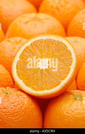 Orange half resting on top of oranges Stock Photo