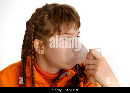 Girl using inhaler Stock Photo