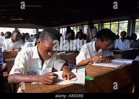 Students in a classroom at their desks writing, Moshi, Tanzania Stock Photo