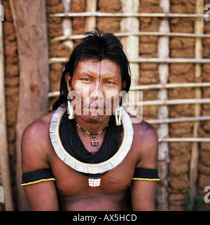 A-Ukre Village, Xingu, Brazil. Krut, a Kayapo man, in front of a wattle and daub house. Stock Photo