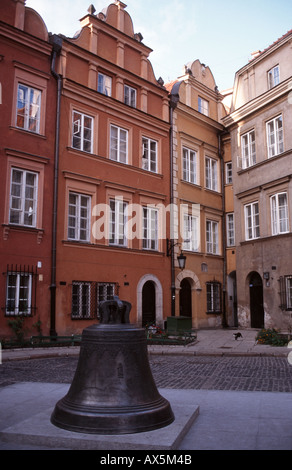 Warsaw, Poland. Cracked cathedral bell with typical buildings from the Old Town. The bell was cast in 1646 by Daniel Tym. Kanonia Square. Stock Photo