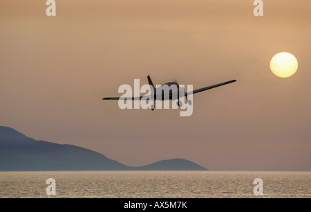 Piper aircraft flying in the evening sun over the ocean (composite shot), Egelsbach, Hesse, Germany, Europe Stock Photo